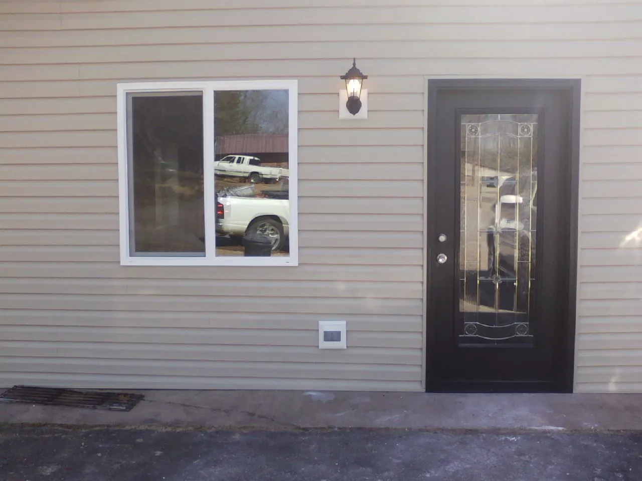 New siding, window and entry door on the side of an addition in Wheatland
